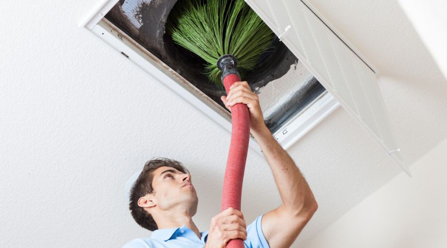 an HVAC technician doing air duct cleaning